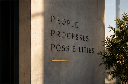 Engraved wall lettering reading people, processes, possibilities